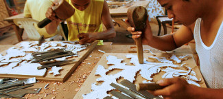 Men carve a pattern from a paper template. Jepara, Central Java, Indonesia. Photo by Murdani Usman/CIFOR via Flickr